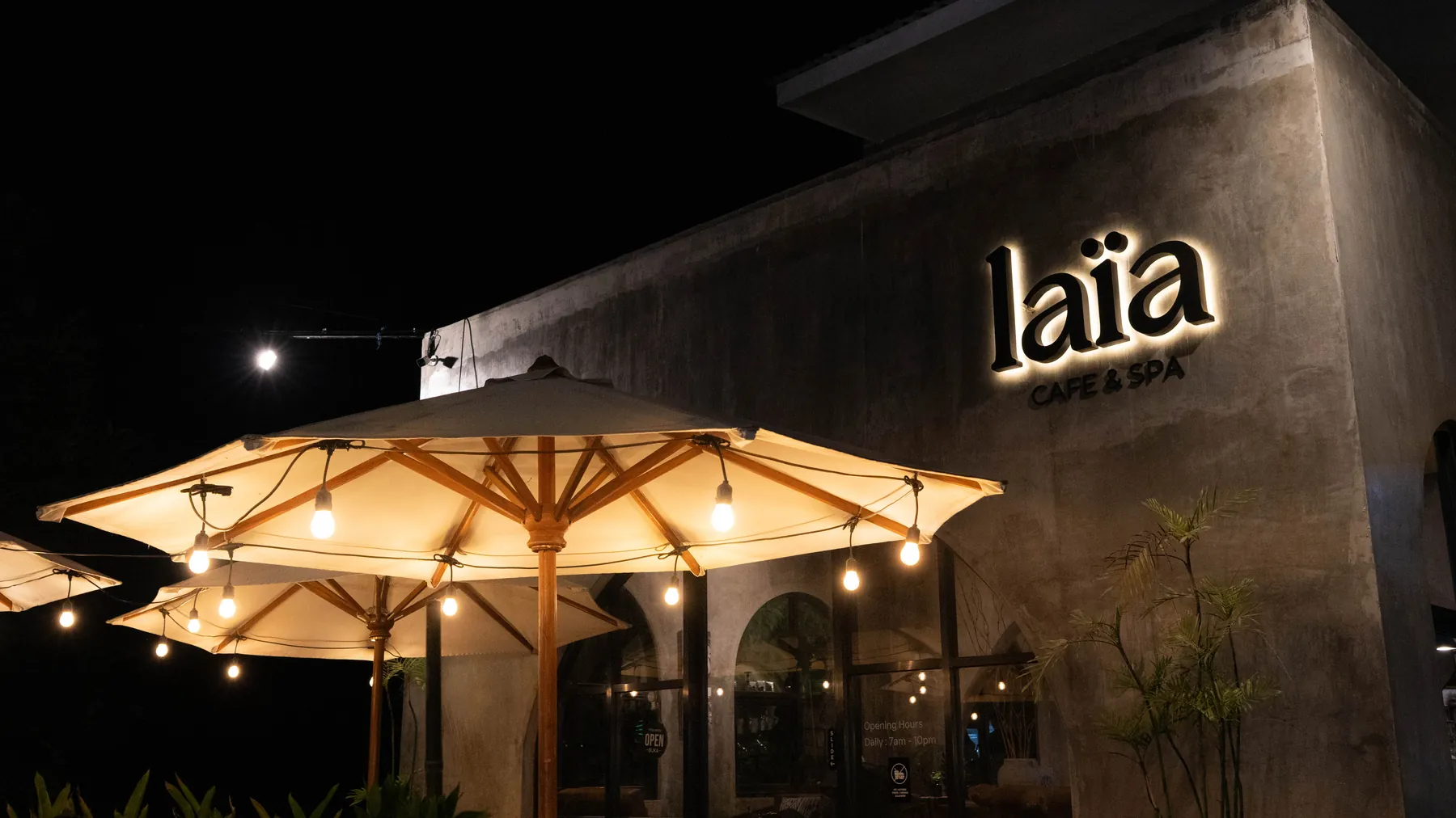 The laïa storefront lit up at night